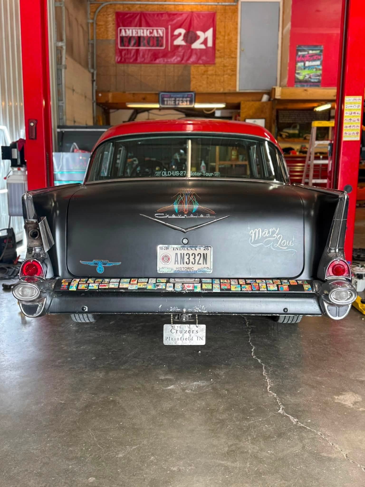 Rear view of the 1957 Chevy Bel Air Mary Lou with vintage travel stickers on the bumper
